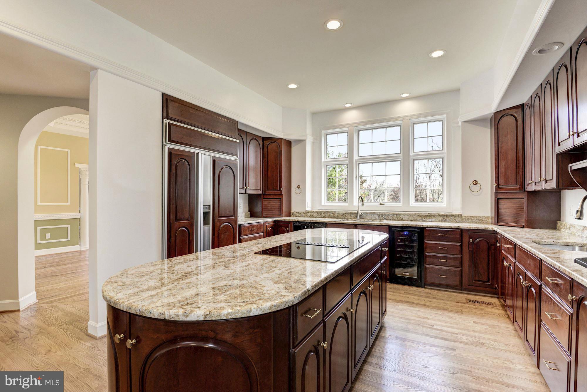 11112 Potomac View Drive Potomac, MD 20854 - Photo 9 of 30 a kitchen with stainless steel appliances granite countertop a sink a stove a refrigerator and a center island