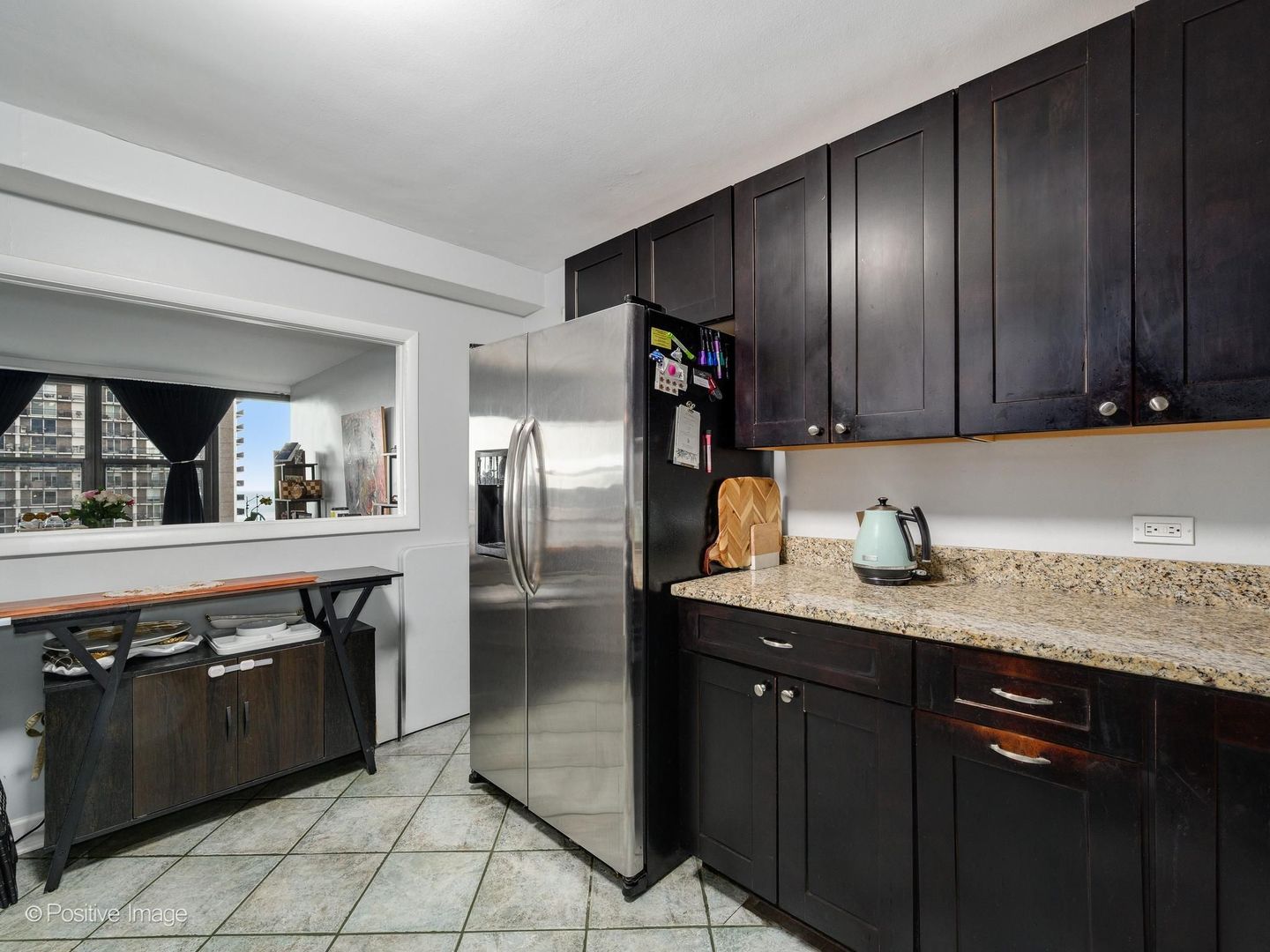 5801 North Sheridan Road, Unit 16B Chicago, IL 60660 - Photo 13 of 23 a kitchen with stainless steel appliances granite countertop a refrigerator and a sink
