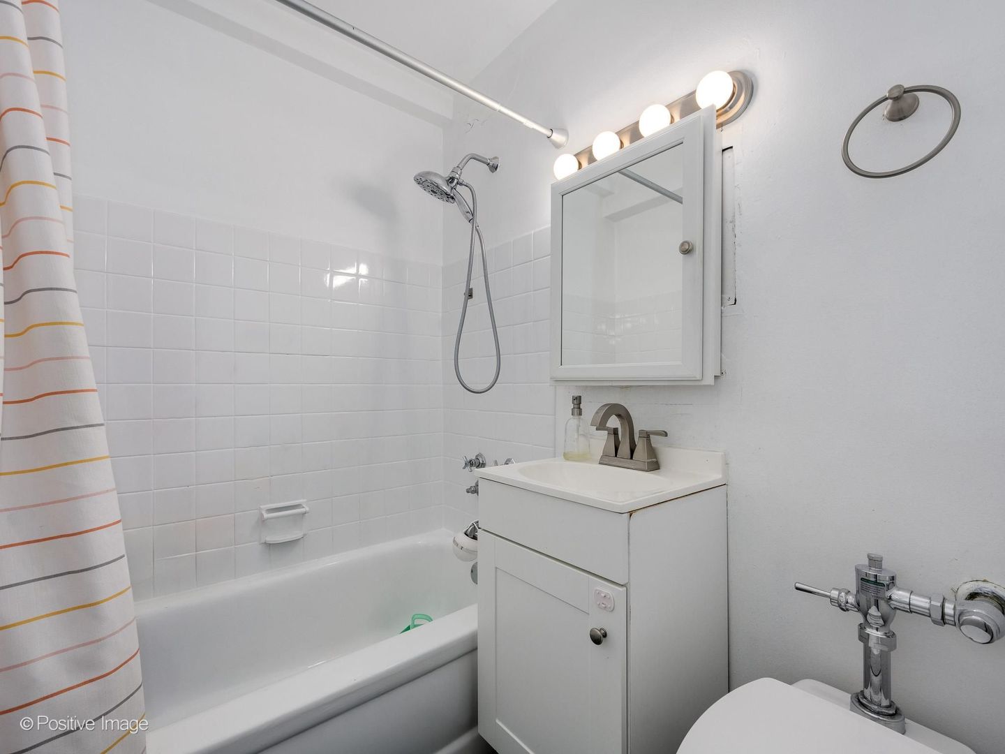 5801 North Sheridan Road, Unit 16B Chicago, IL 60660 - Photo 16 of 23 a bathroom with a sink a toilet and shower
