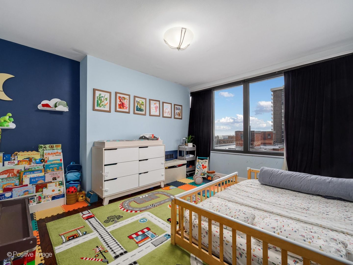 5801 North Sheridan Road, Unit 16B Chicago, IL 60660 - Photo 17 of 23 a bed room with a bed and a baby bed