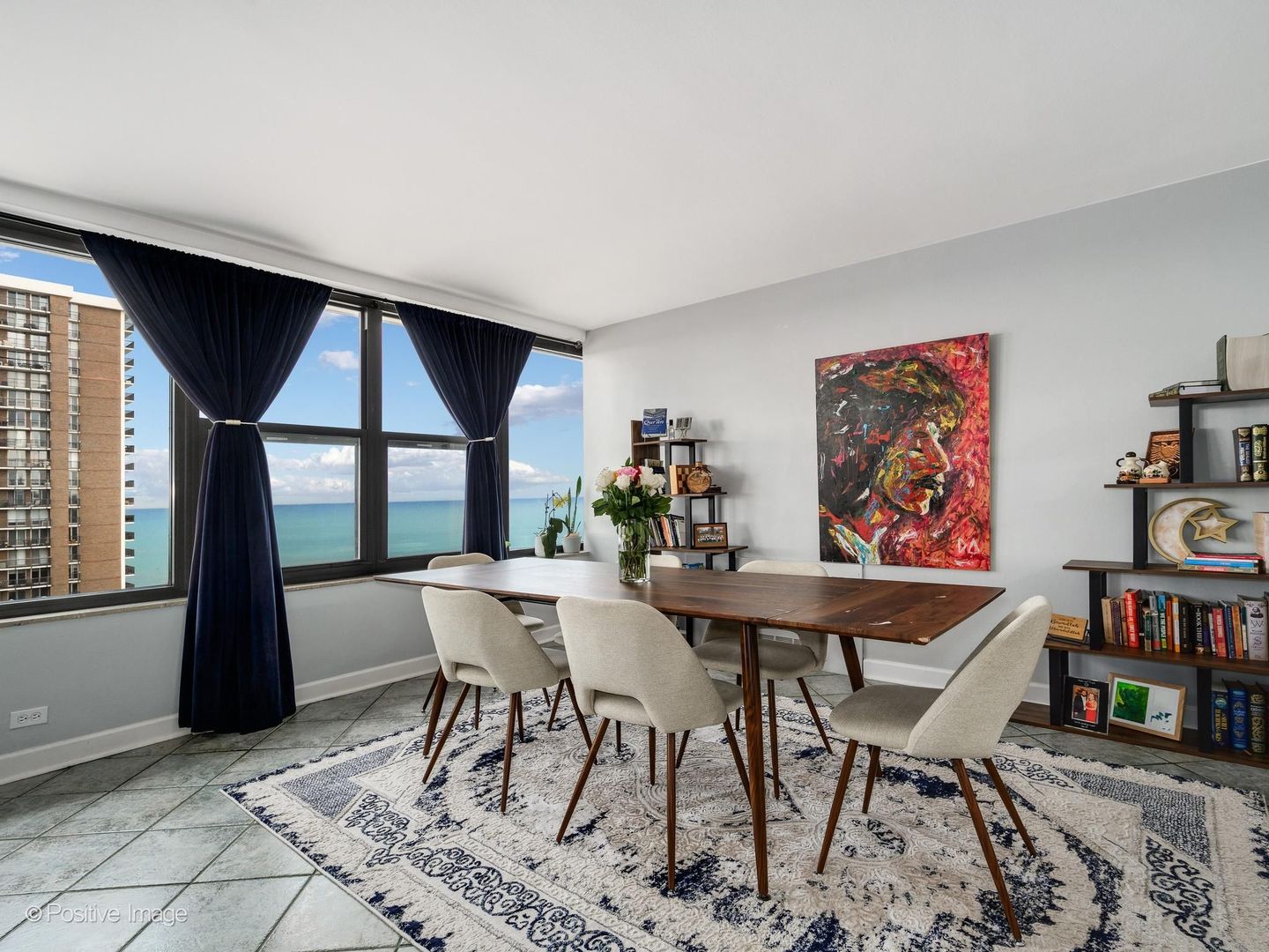 5801 North Sheridan Road, Unit 16B Chicago, IL 60660 - Photo 5 of 23 a view of a dining room with furniture window and wooden floor