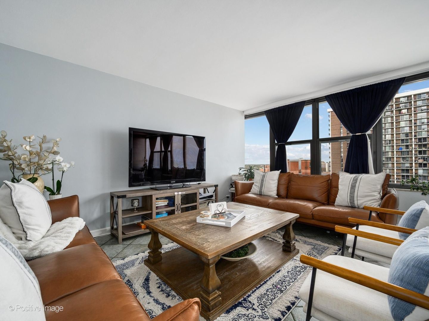 5801 North Sheridan Road, Unit 16B Chicago, IL 60660 - Photo 6 of 23 a living room with furniture and a flat screen tv