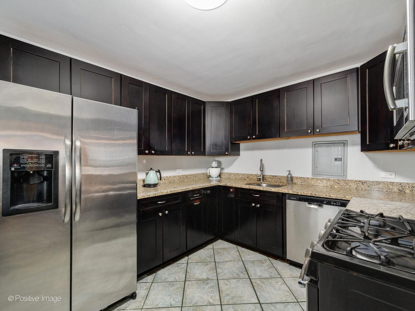 5801 North Sheridan Road, Unit 16B Chicago, IL 60660 - Photo 10 of 23 a kitchen with a sink stove and refrigerator