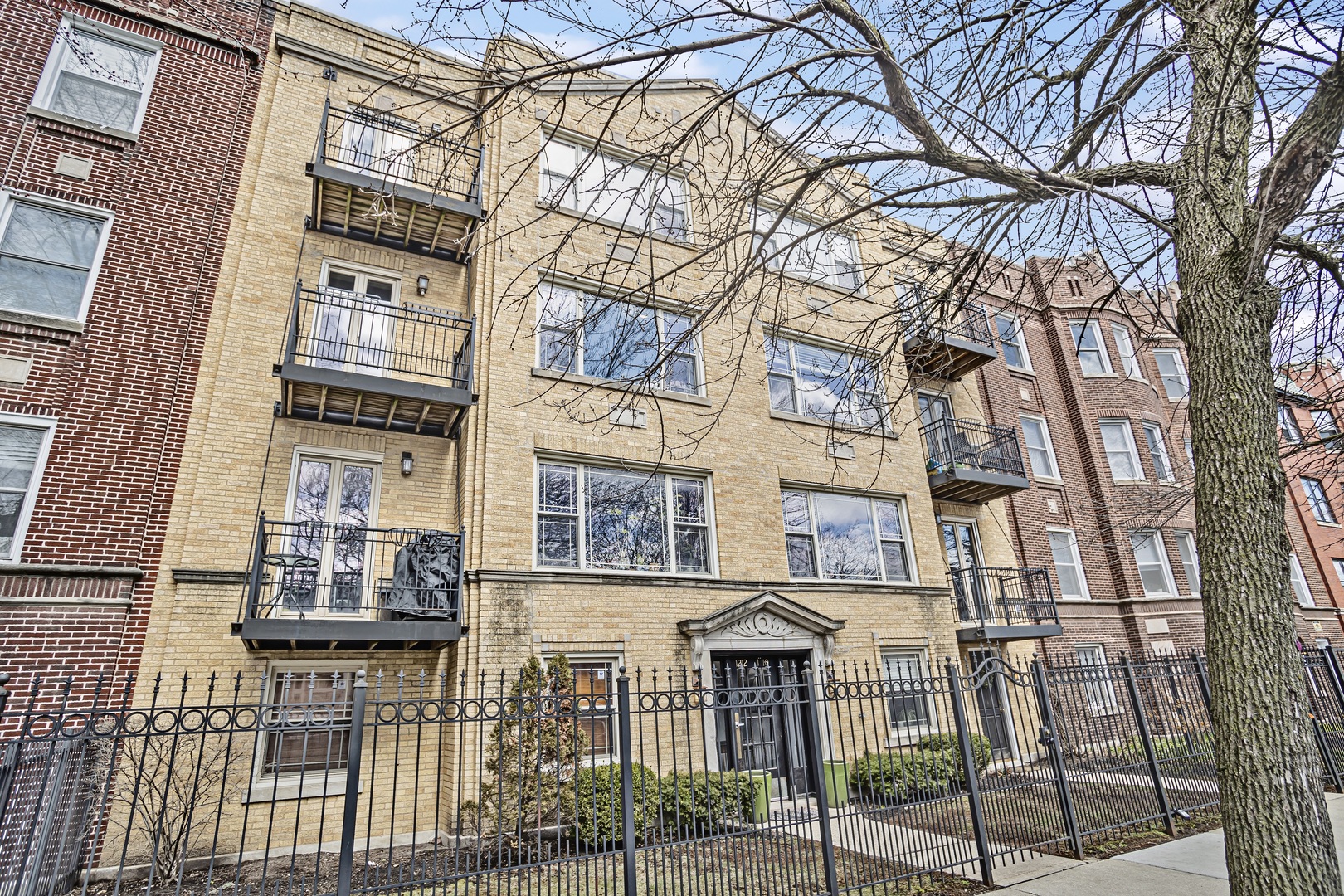 a front view of a residential apartment building with a yard