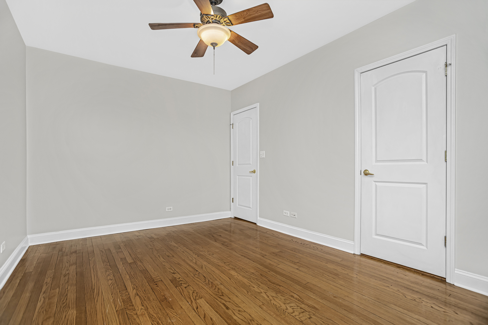 1210 West Roscoe Street, Unit 1 Chicago, IL 60657 - Photo 15 of 20 a view of room with wooden floor and ceiling fan