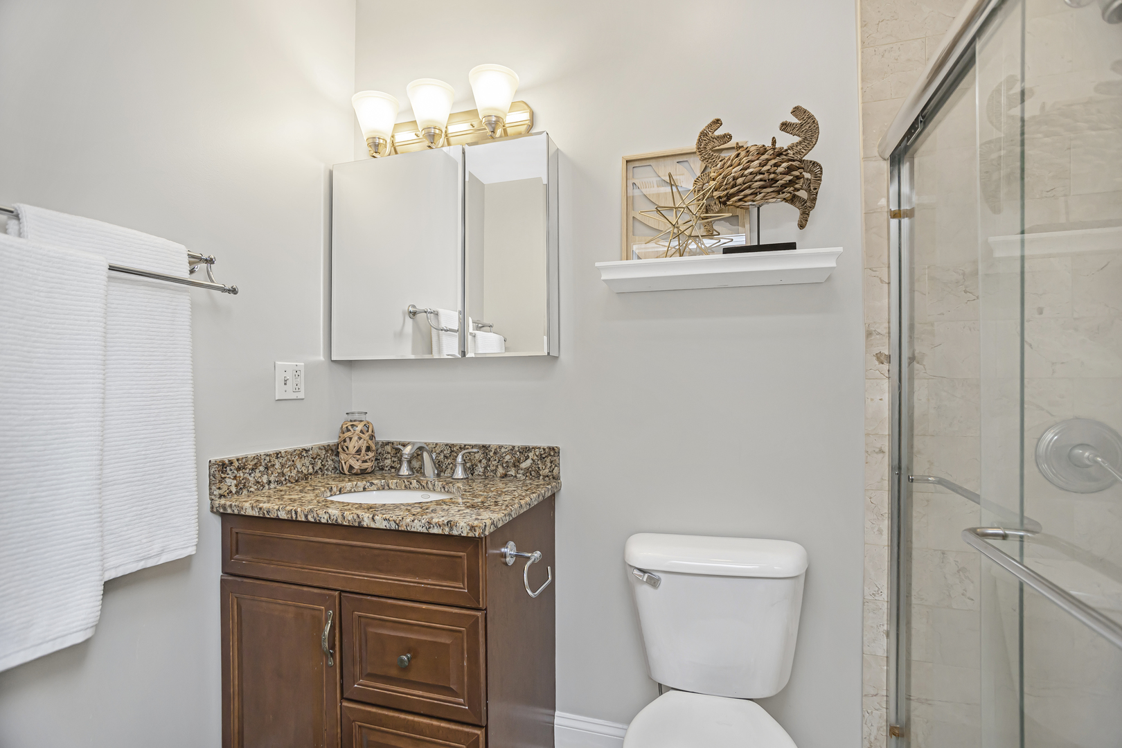 1210 West Roscoe Street, Unit 1 Chicago, IL 60657 - Photo 17 of 20 a bathroom with a toilet sink and mirror