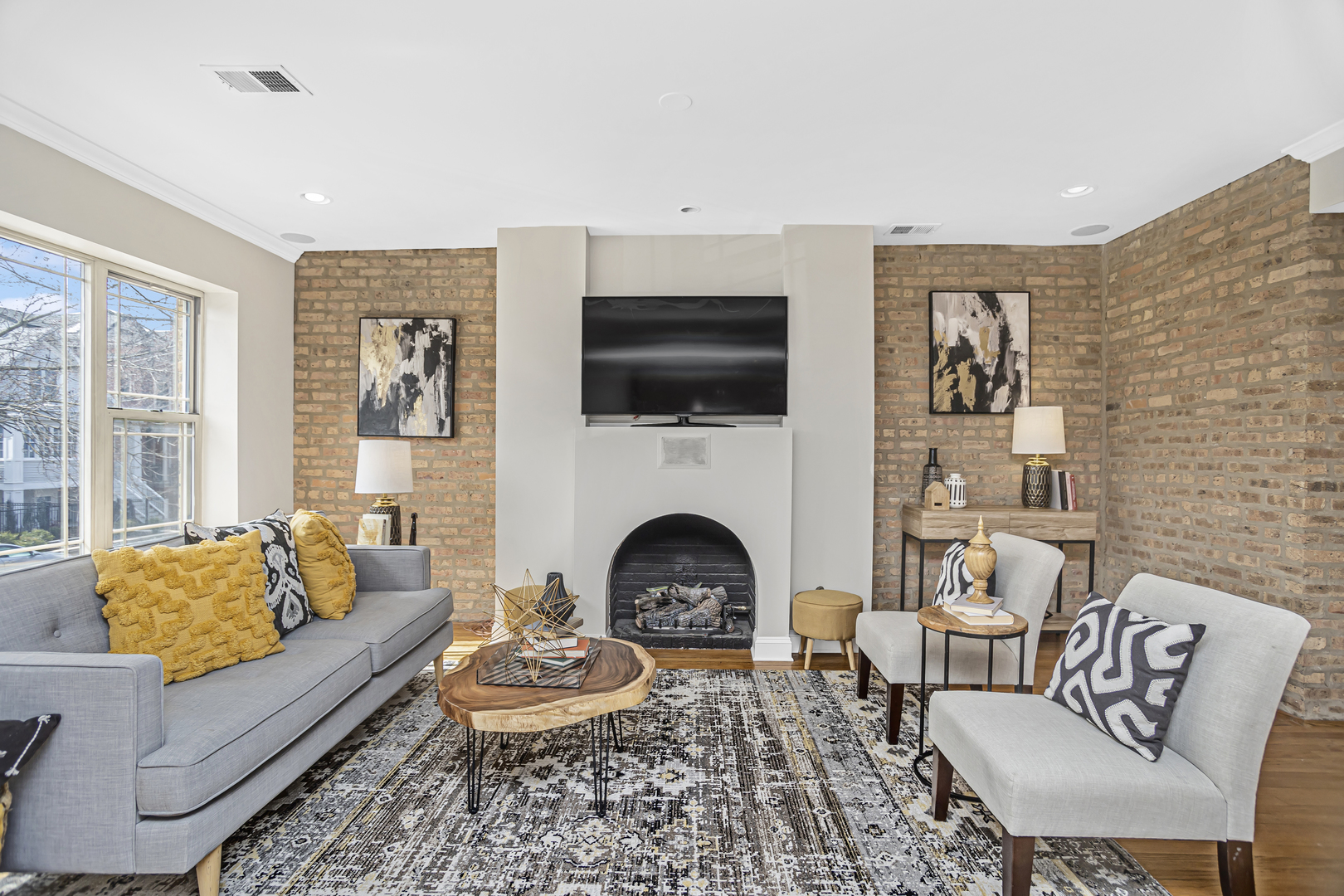 1210 West Roscoe Street, Unit 1 Chicago, IL 60657 - Photo 4 of 20 a living room with furniture a flat screen tv and a fireplace