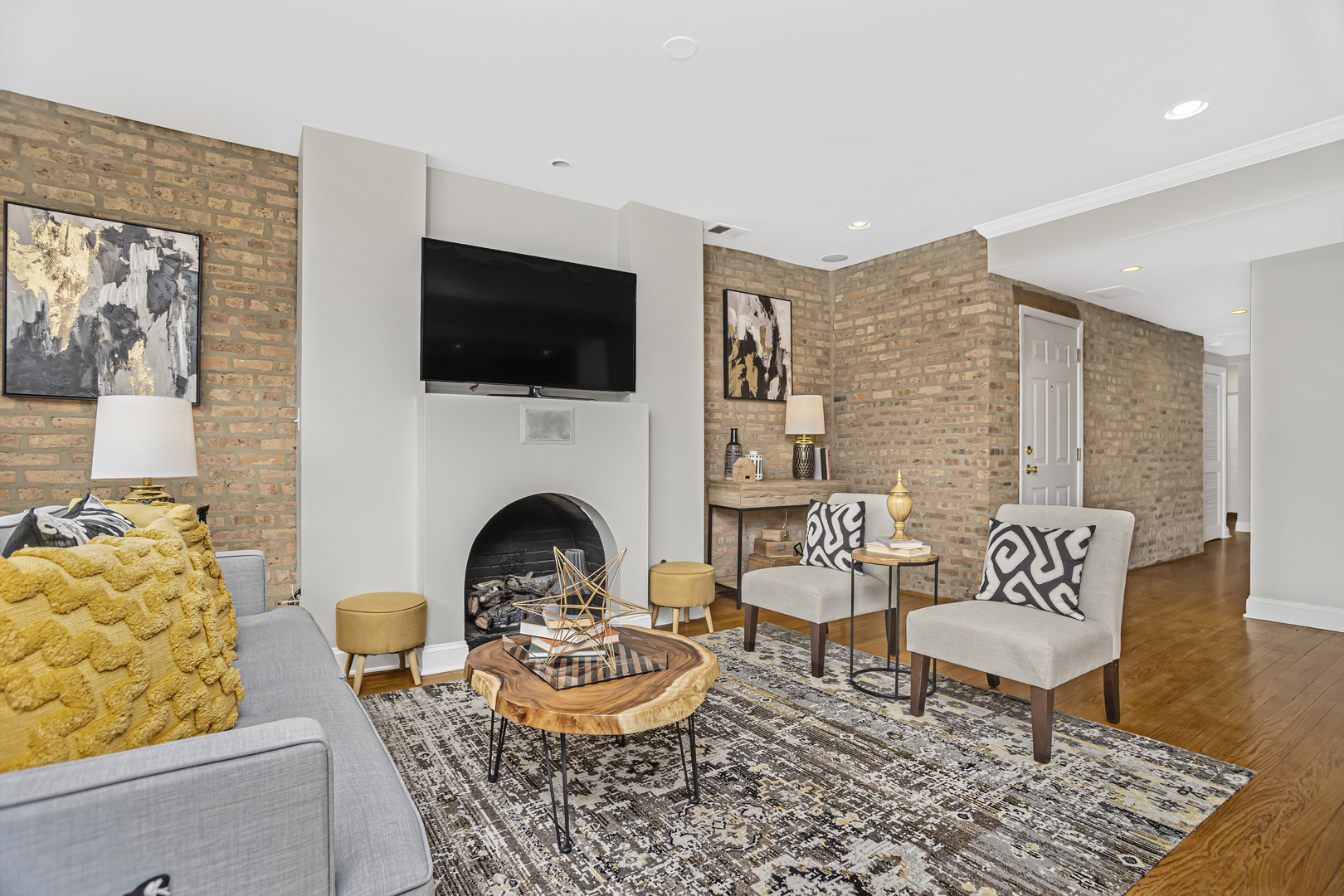 1210 West Roscoe Street, Unit 1 Chicago, IL 60657 - Photo 5 of 20 a living room with furniture and a fireplace