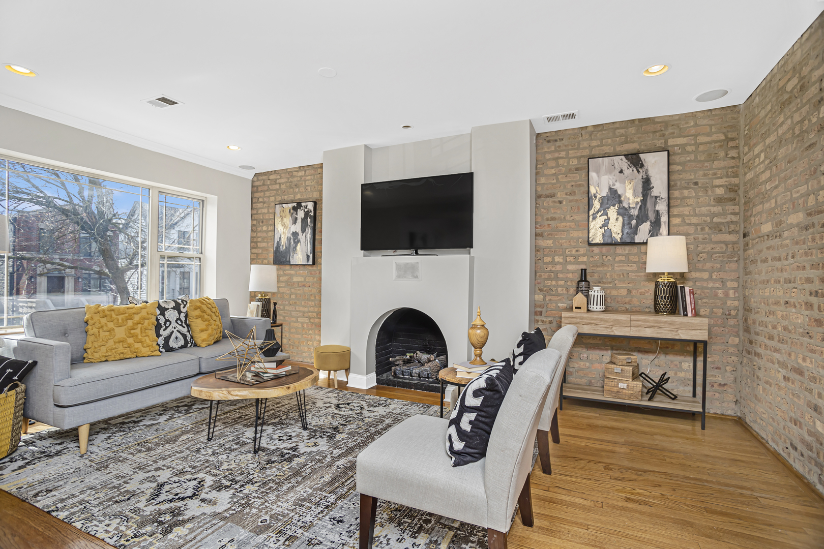 1210 West Roscoe Street, Unit 1 Chicago, IL 60657 - Photo 6 of 20 a living room with furniture a flat screen tv and a fireplace