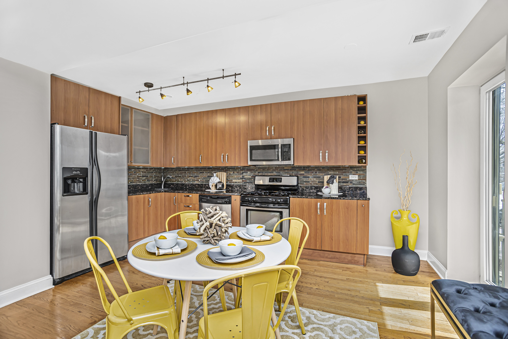 1210 West Roscoe Street, Unit 1 Chicago, IL 60657 - Photo 8 of 20 a view of a dining room with furniture and a kitchen view