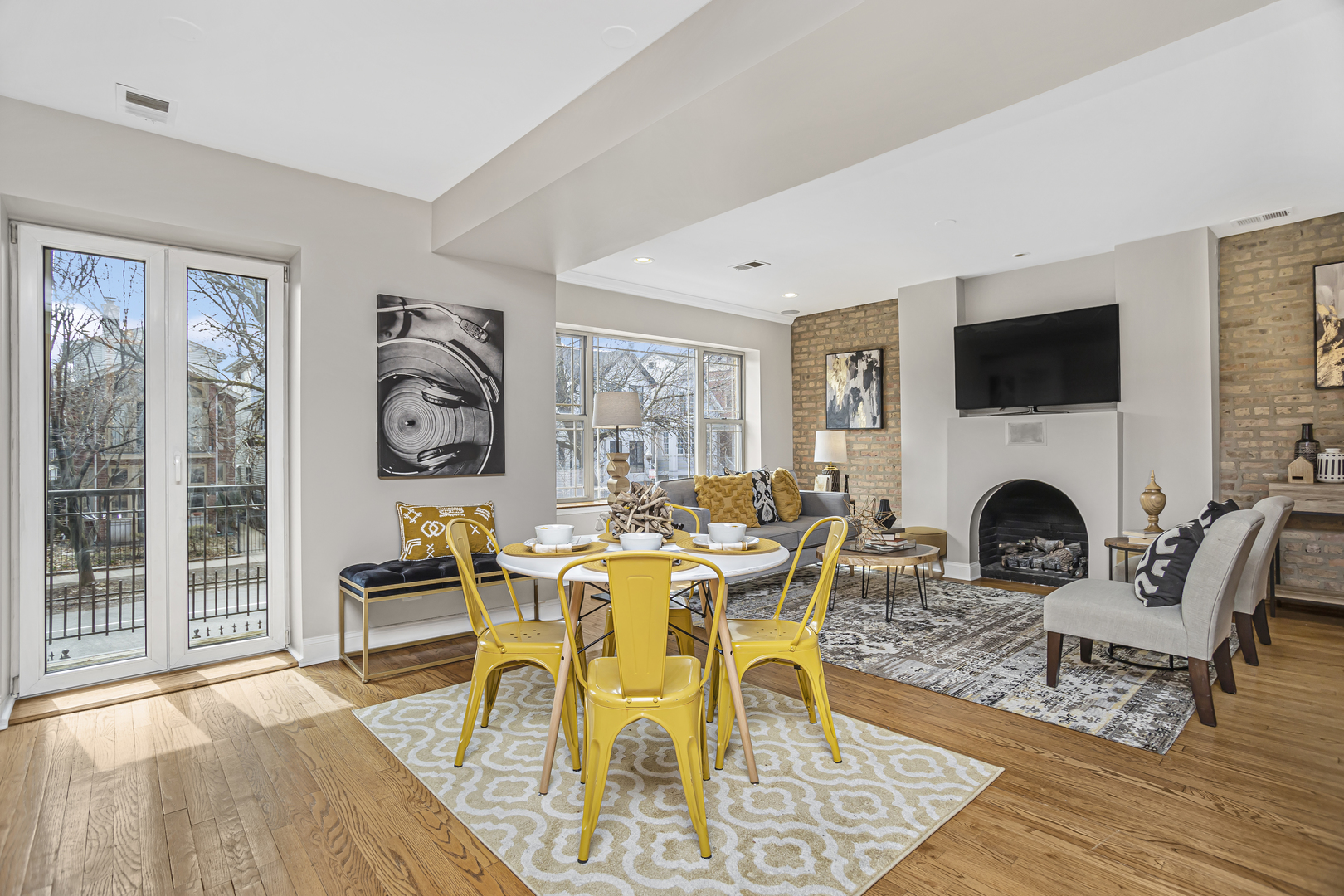 1210 West Roscoe Street, Unit 1 Chicago, IL 60657 - Photo 9 of 20 a living room with furniture a fireplace and a flat screen tv