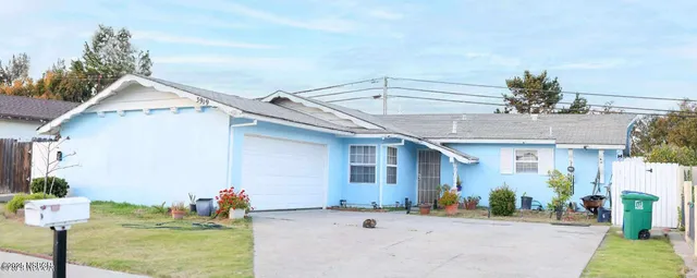 a view of a porch with a table and chairs