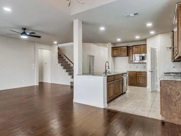 an empty room with windows and entrance to other room