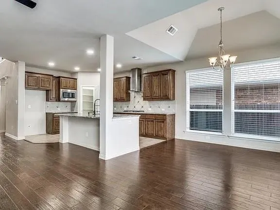 a view of a house with a wooden fence