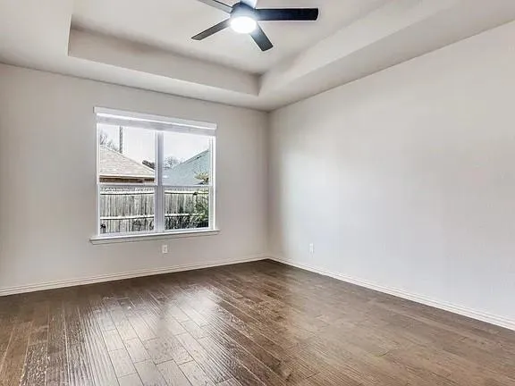 a large kitchen with cabinets wooden floor and stainless steel appliances