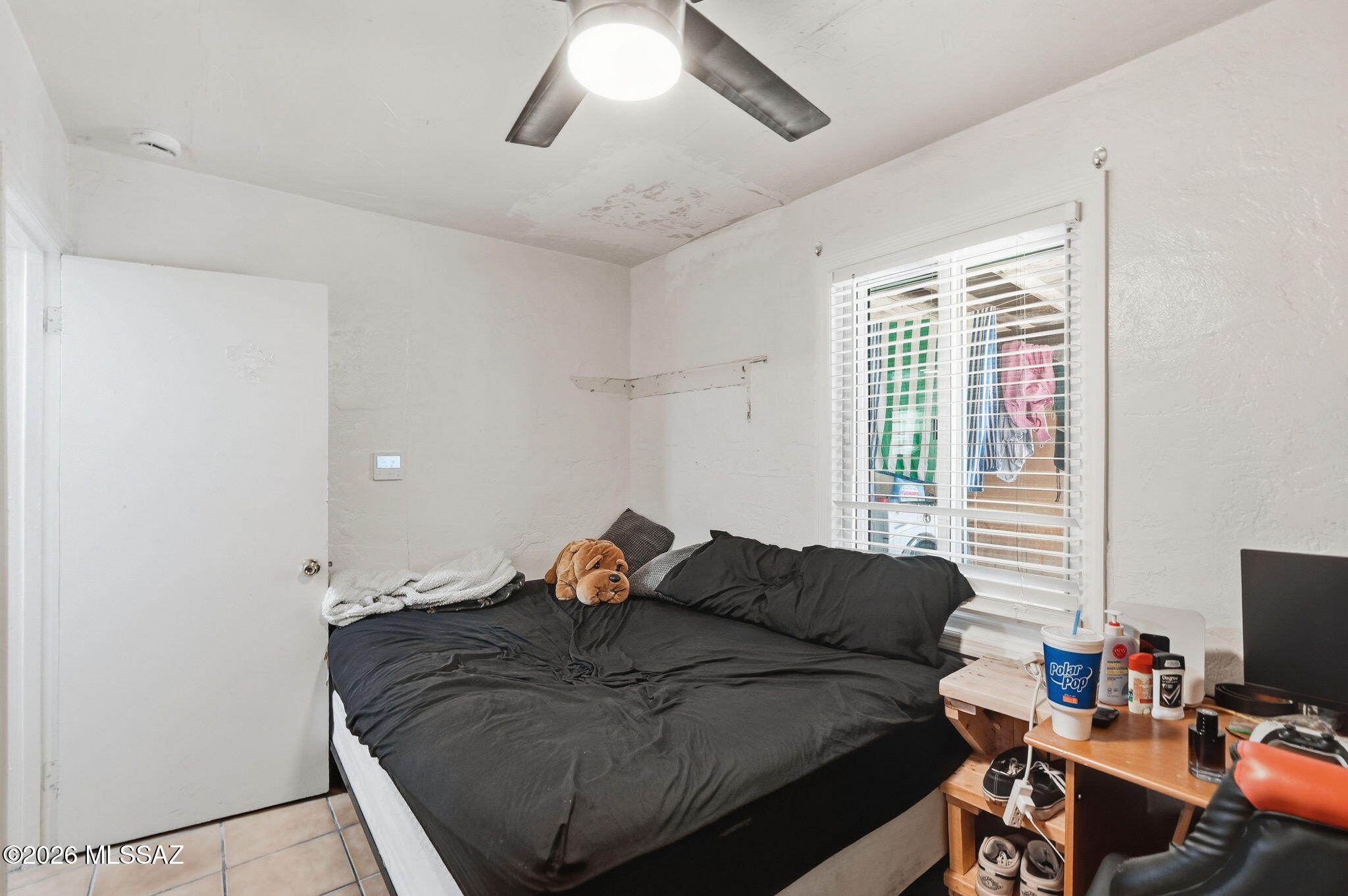 426 East Aragon Road, Unit 1 Tucson, AZ 85756 - Photo 14 of 18 a bedroom with a bed and a window