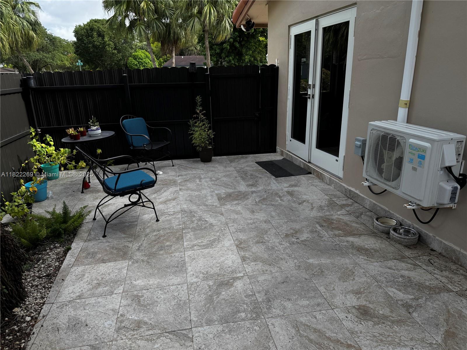 a backyard of a house with table and chairs