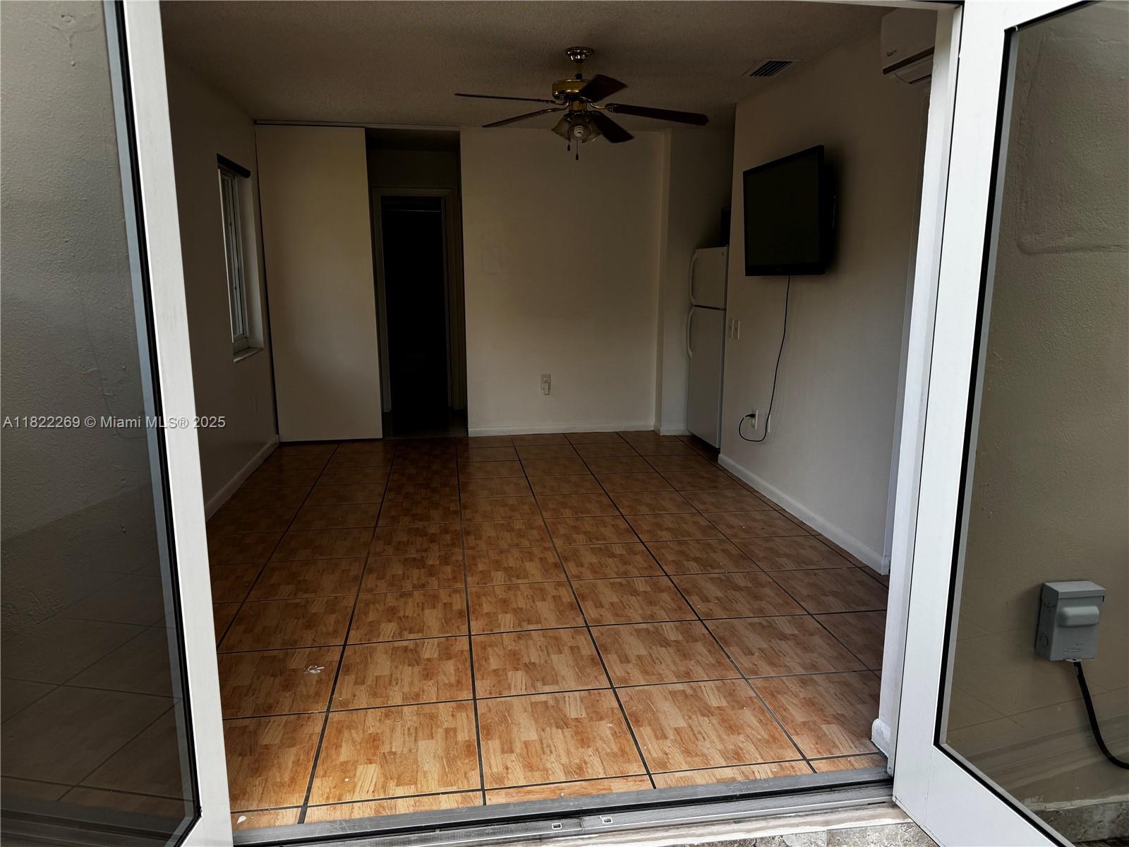 The Crossings Miami, FL 33186 - Photo 2 of 5 an empty room with wooden floor and windows
