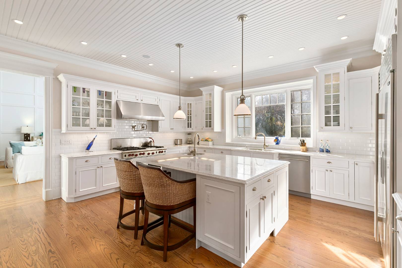 22 Gardiners Path Sag Harbor, NY 11963 - Photo 3 of 13 a large kitchen with kitchen island granite countertop lots of white cabinets appliances and a dining table