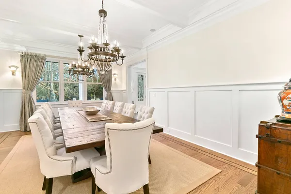 a dining room with furniture a chandelier and window