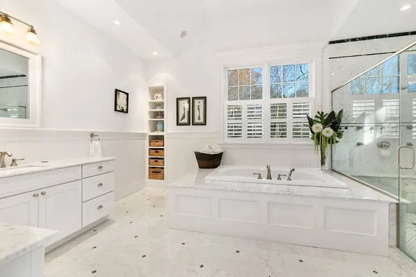 a bathroom with a double vanity sink window and flower