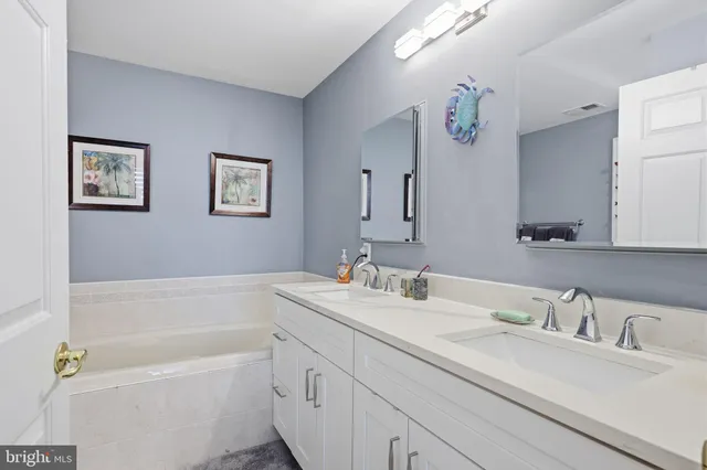 a bathroom with a sink toilet and a mirror