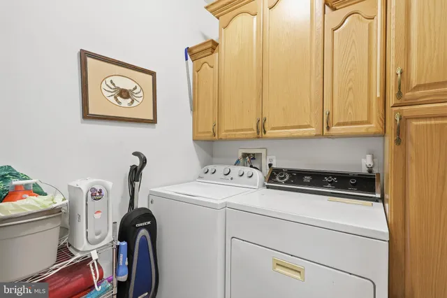 a storage & utility room with wooden floor and windows