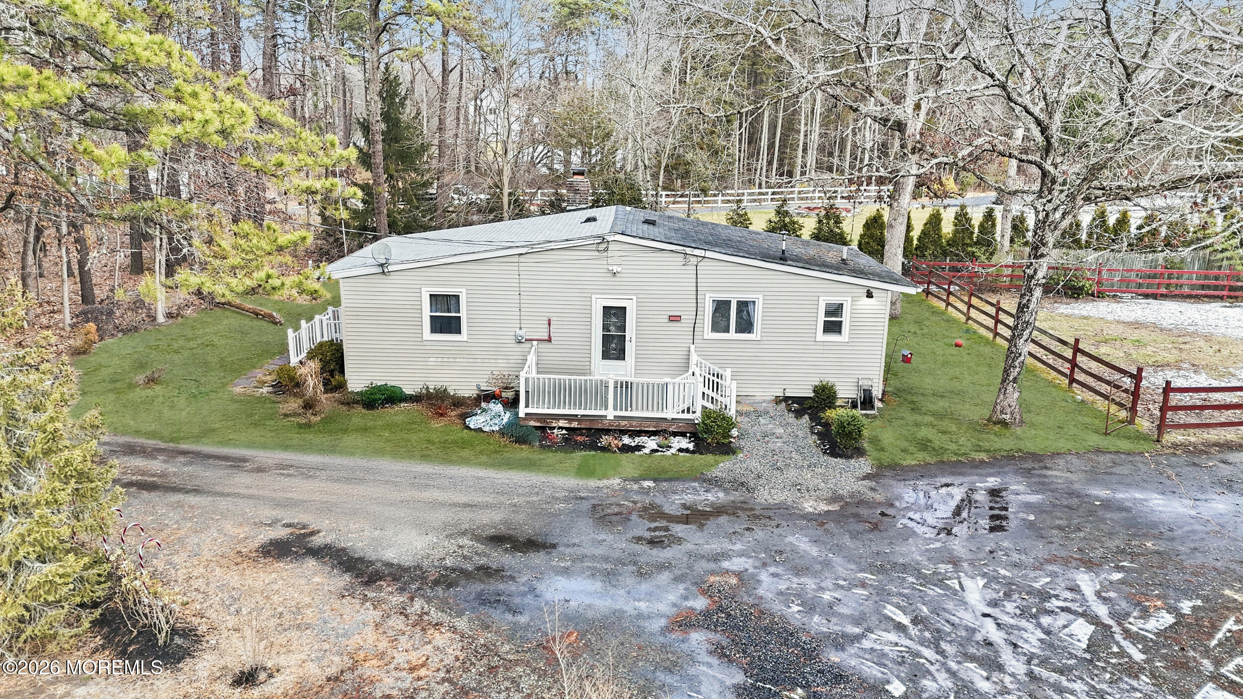 283 East Pleasant Grove Road Jackson, NJ 08527 - Photo 1 of 10 a view of a white house next to a yard with a large tree