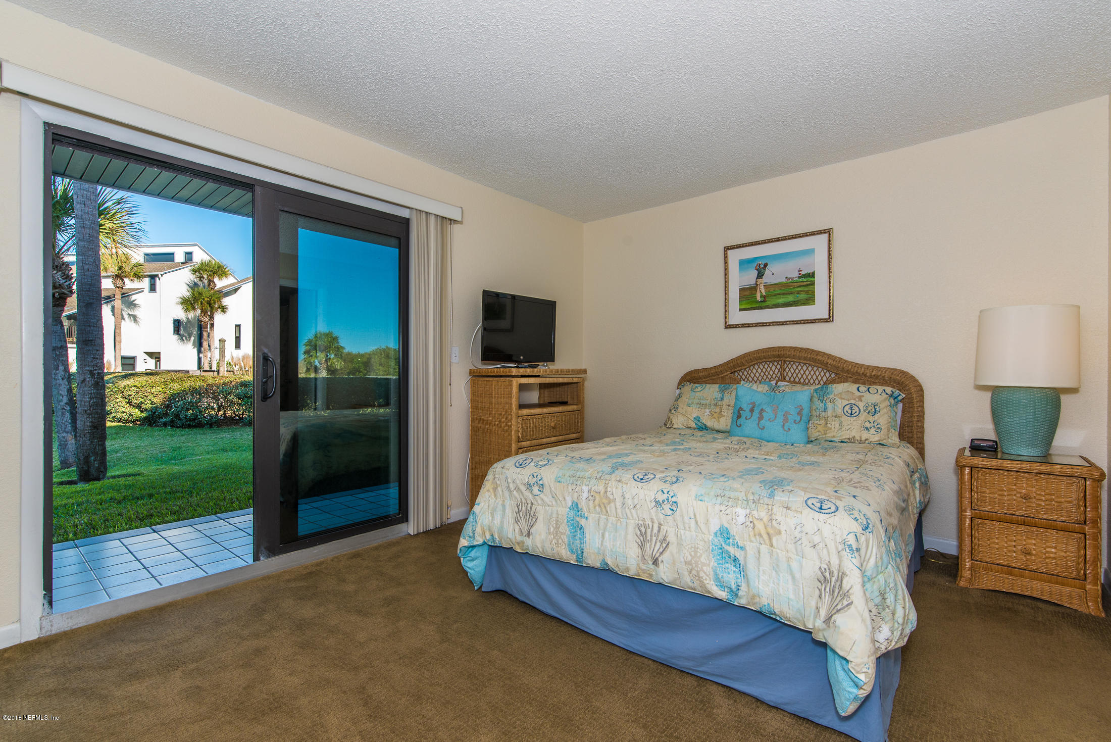 890 A1A Beach Boulevard, Unit 50 St. Augustine, FL 32080 - Photo 11 of 71 a bedroom with a bed and a view of living room