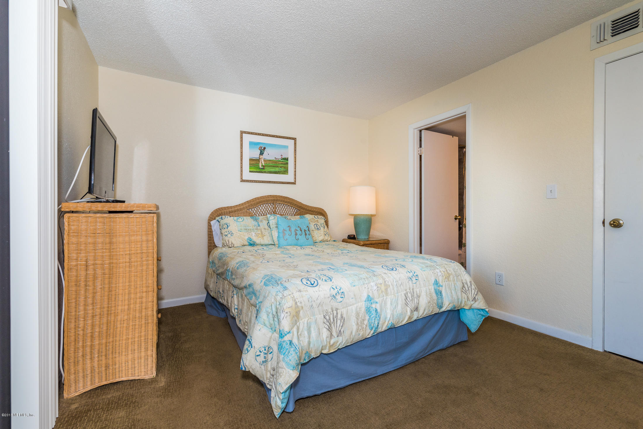 890 A1A Beach Boulevard, Unit 50 St. Augustine, FL 32080 - Photo 12 of 71 a bedroom with a bed and a painting on the wall