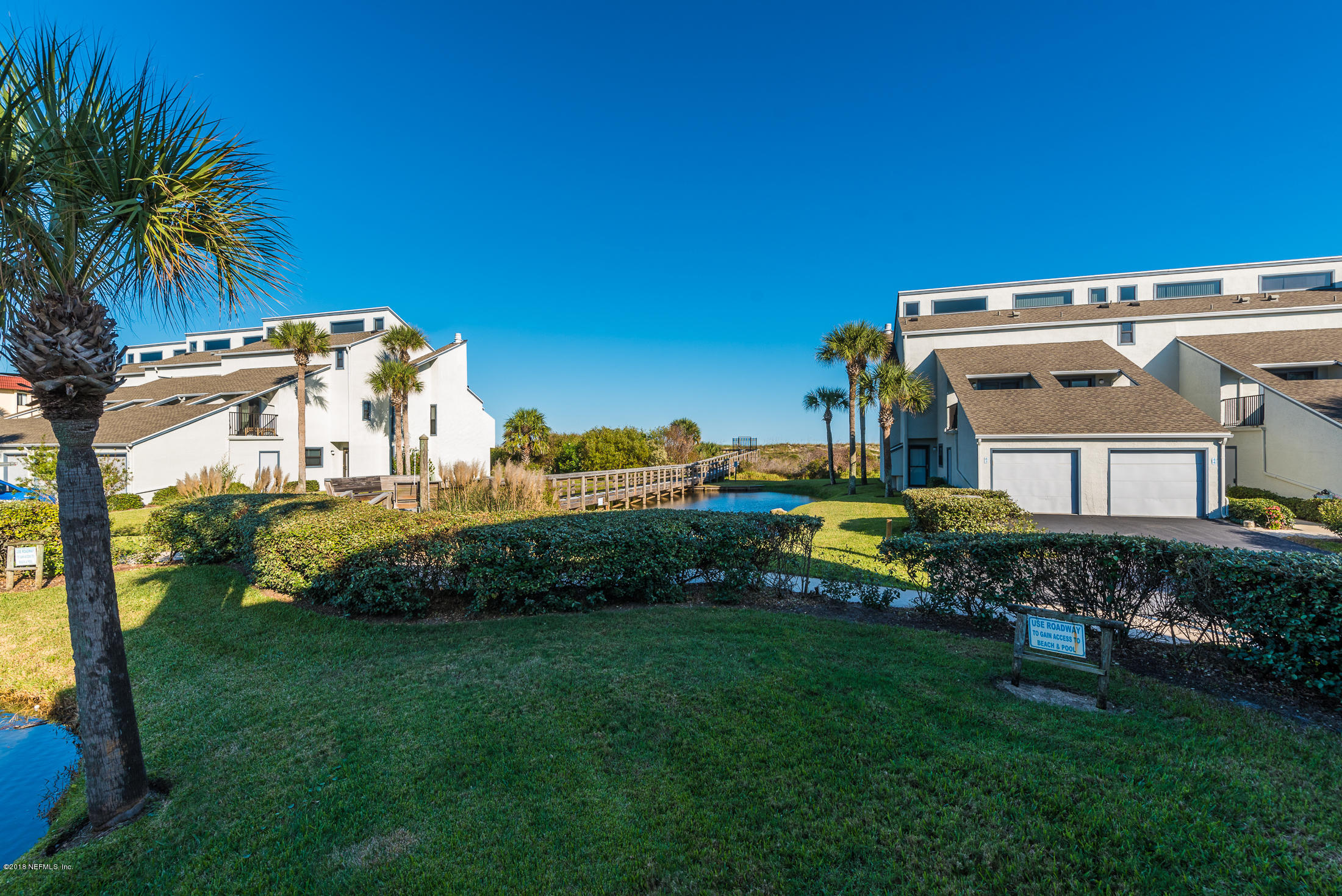 890 A1A Beach Boulevard, Unit 50 St. Augustine, FL 32080 - Photo 14 of 71 a view of a house with a big yard and potted plants