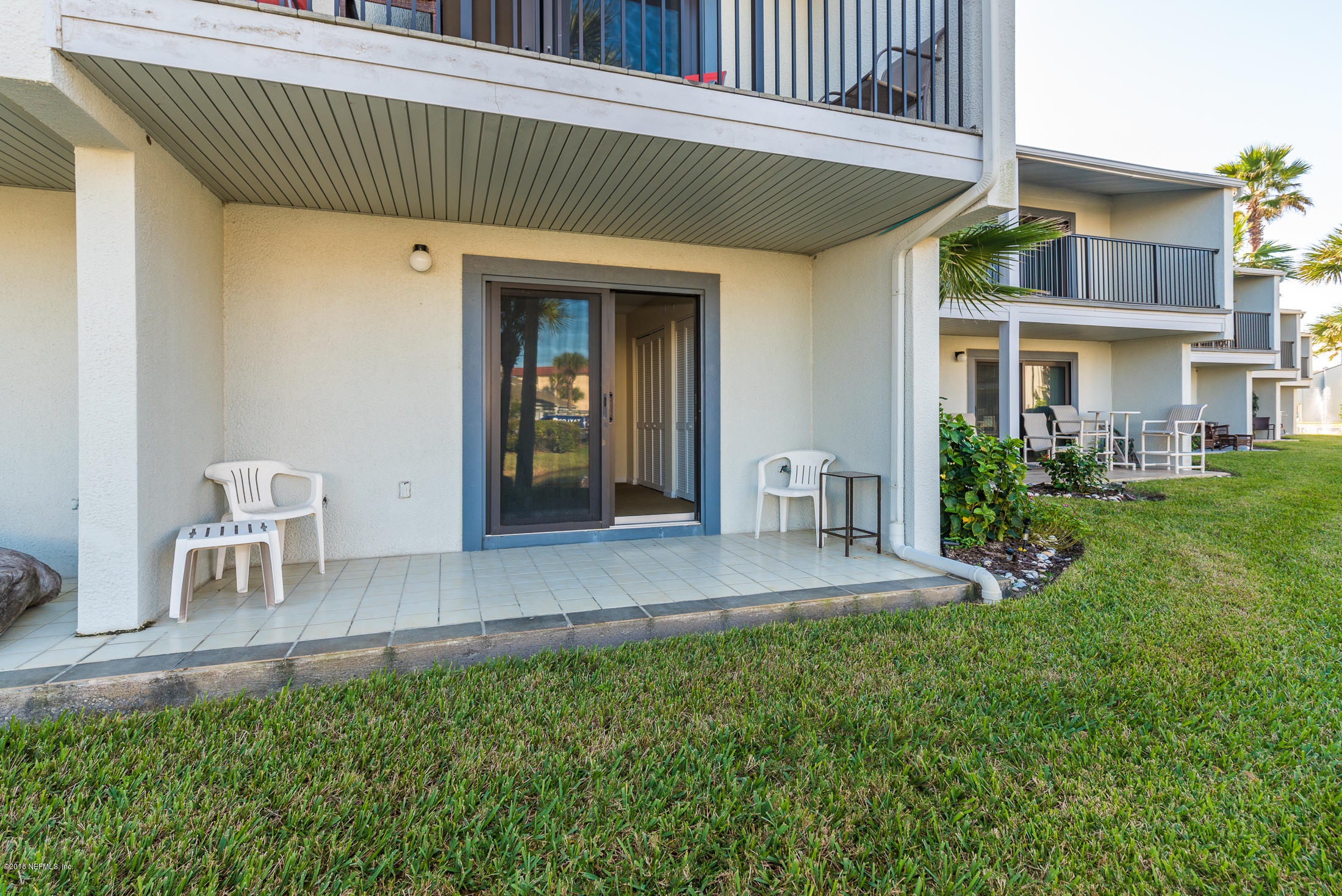 890 A1A Beach Boulevard, Unit 50 St. Augustine, FL 32080 - Photo 15 of 71 a view of a house with a yard and sitting area