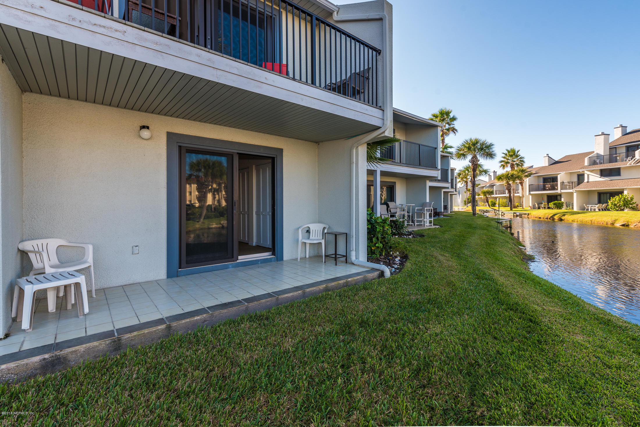 890 A1A Beach Boulevard, Unit 50 St. Augustine, FL 32080 - Photo 16 of 71 a view of a patio with table and chairs and potted plants