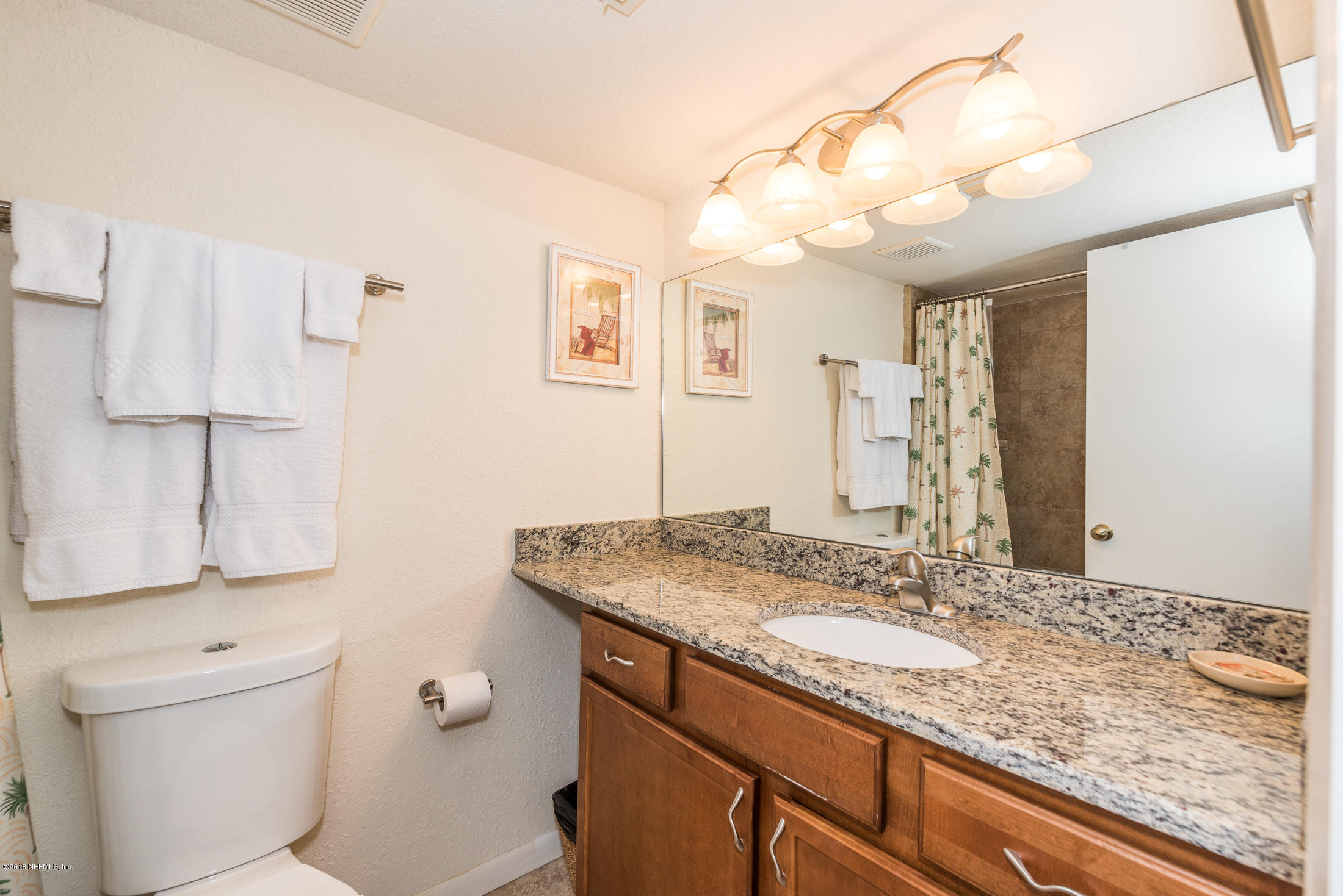 890 A1A Beach Boulevard, Unit 50 St. Augustine, FL 32080 - Photo 18 of 71 a bathroom with a granite countertop sink and a mirror