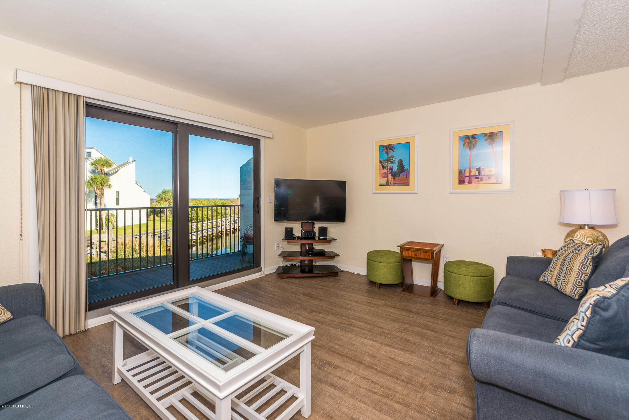 890 A1A Beach Boulevard, Unit 50 St. Augustine, FL 32080 - Photo 32 of 71 a living room with furniture and a flat screen tv
