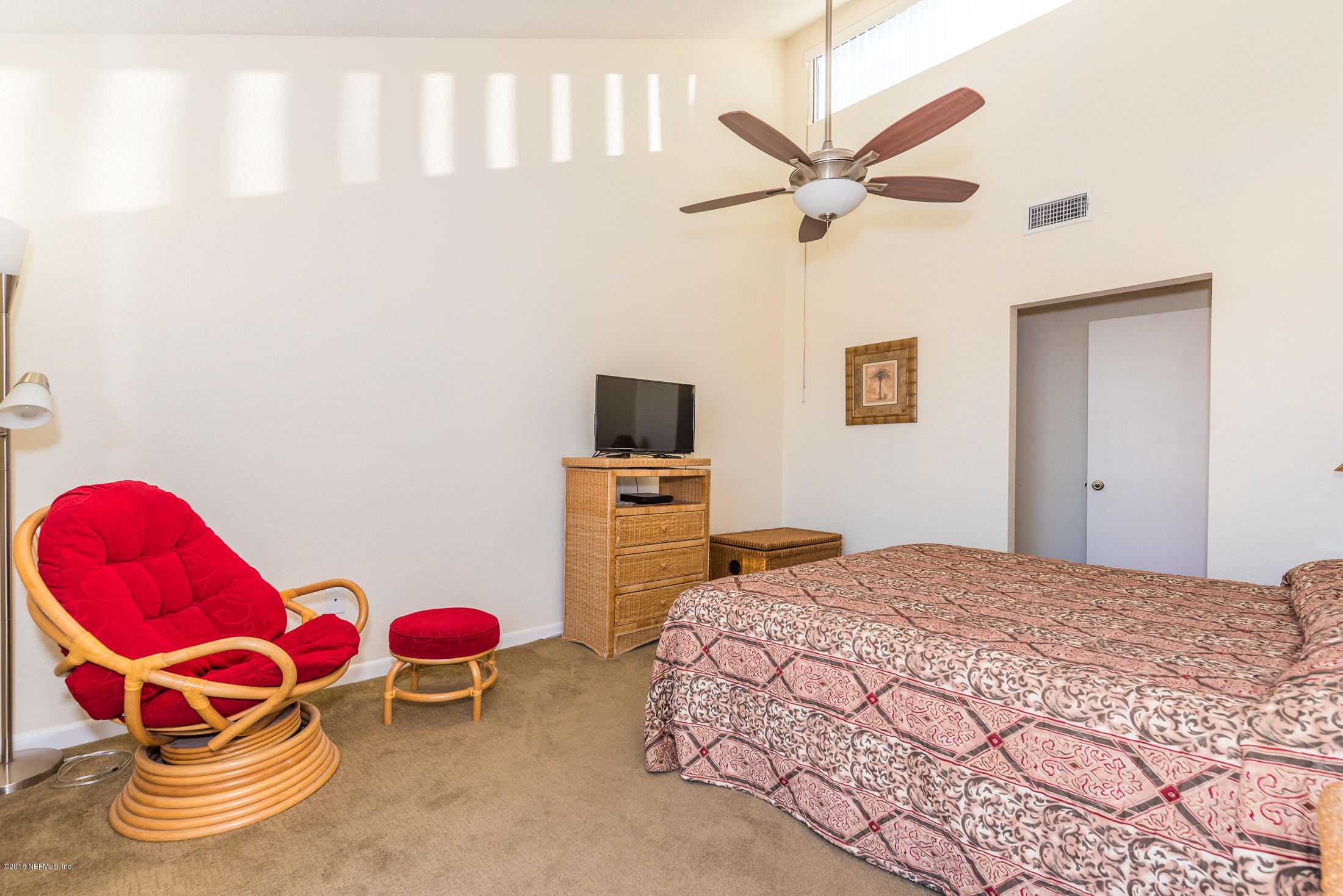 890 A1A Beach Boulevard, Unit 50 St. Augustine, FL 32080 - Photo 44 of 71 a bedroom with a bed and a chandelier