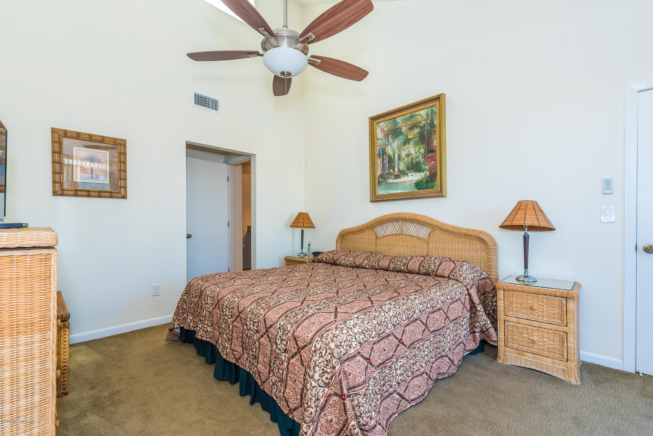890 A1A Beach Boulevard, Unit 50 St. Augustine, FL 32080 - Photo 45 of 71 a bedroom with a bed and a lamp on table