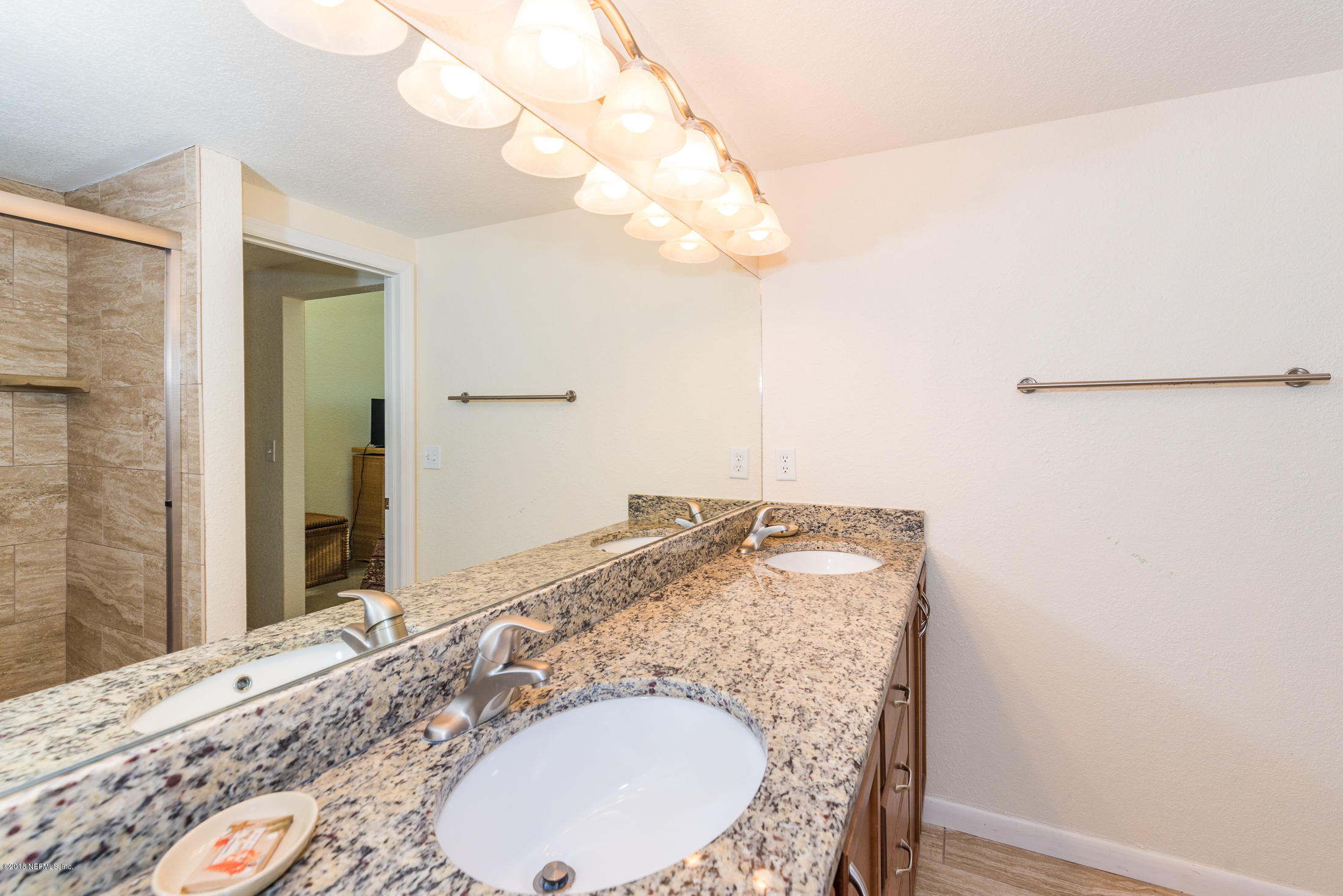 890 A1A Beach Boulevard, Unit 50 St. Augustine, FL 32080 - Photo 49 of 71 a bathroom with a granite countertop sink and a mirror