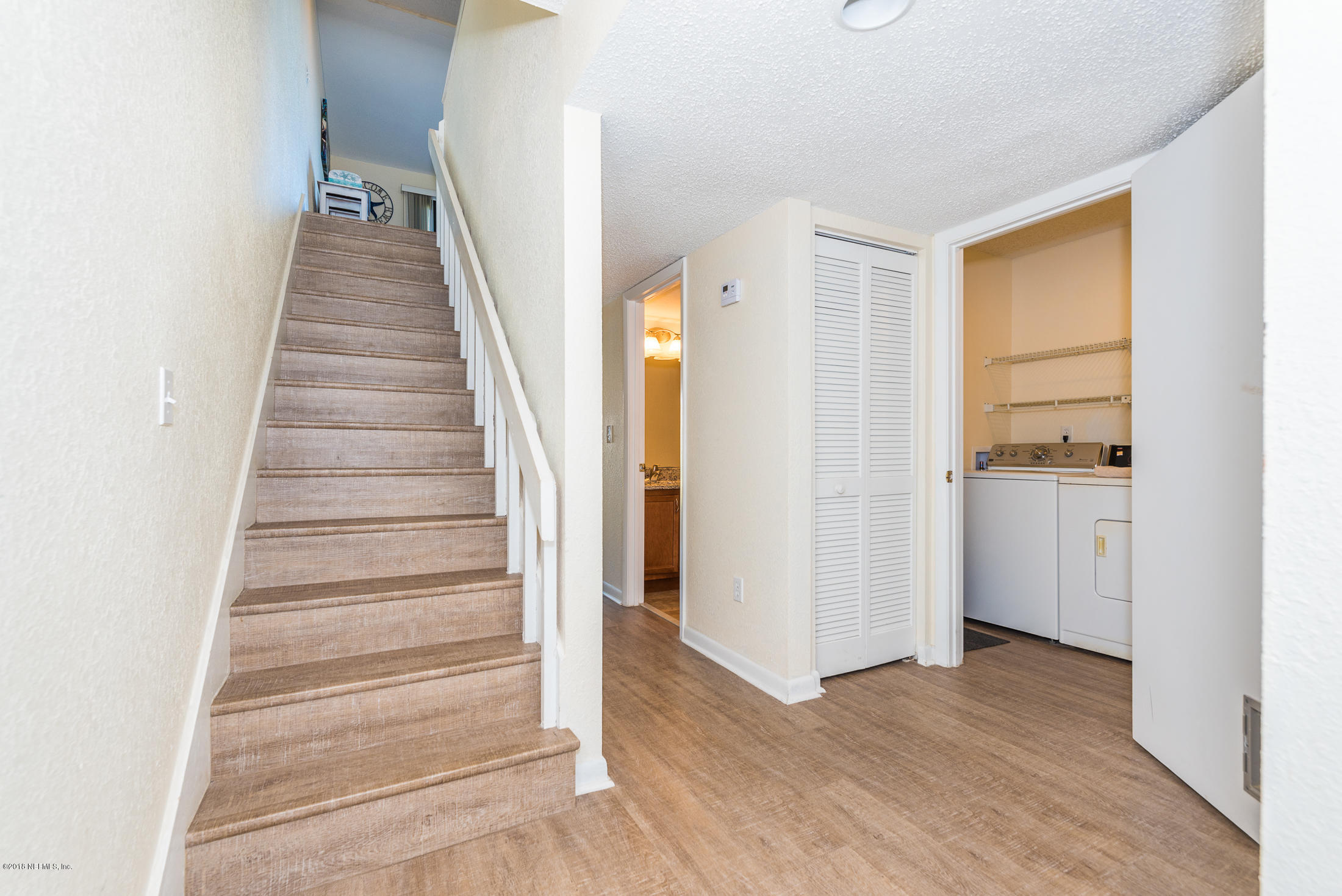 890 A1A Beach Boulevard, Unit 50 St. Augustine, FL 32080 - Photo 6 of 71 a view of an entryway with wooden floor and stairs