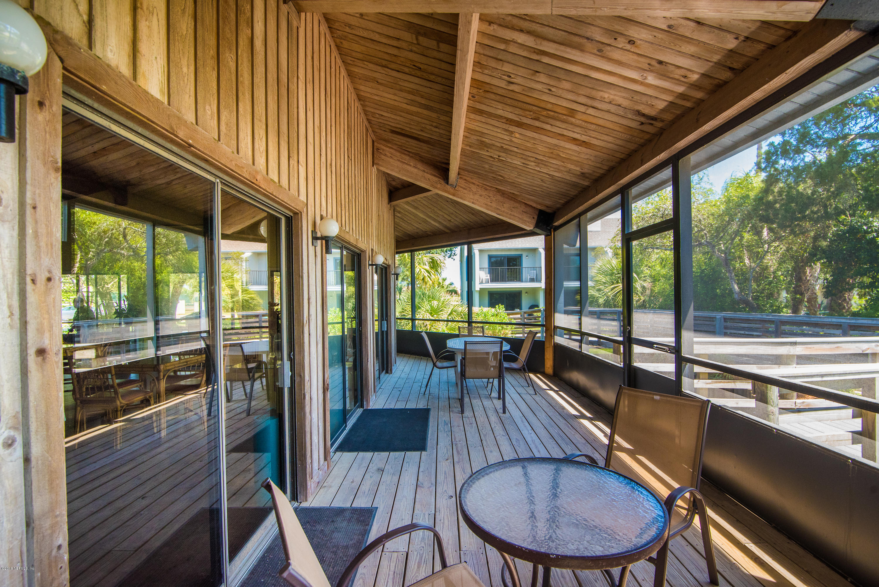 890 A1A Beach Boulevard, Unit 50 St. Augustine, FL 32080 - Photo 66 of 71 a dining room with furniture wooden floor and a potted plant