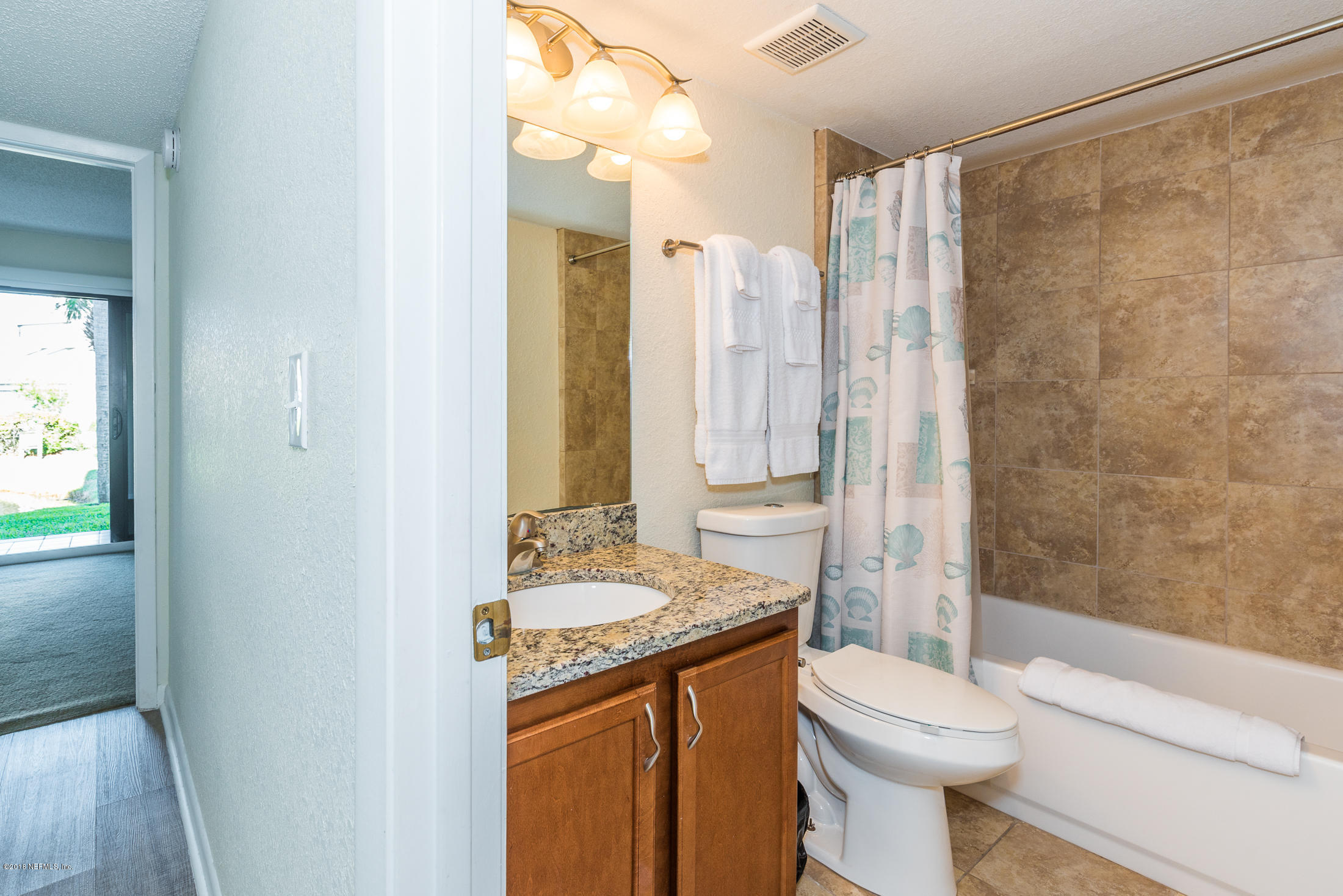 890 A1A Beach Boulevard, Unit 50 St. Augustine, FL 32080 - Photo 9 of 71 a bathroom with a granite countertop sink toilet and shower