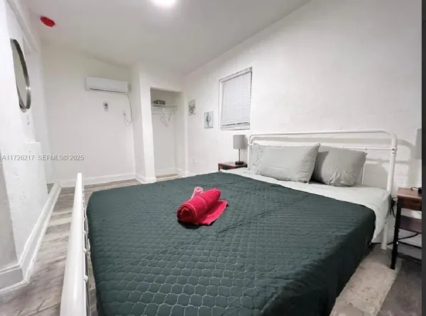 a bedroom with a bed and a couch