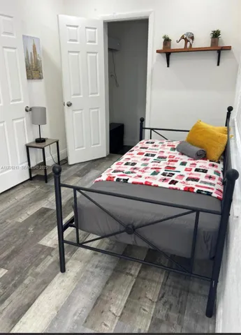 a bedroom with a bed and a chair