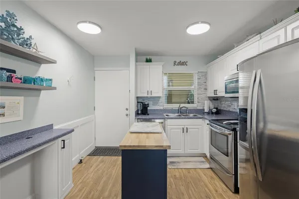 a kitchen with a sink stove and refrigerator