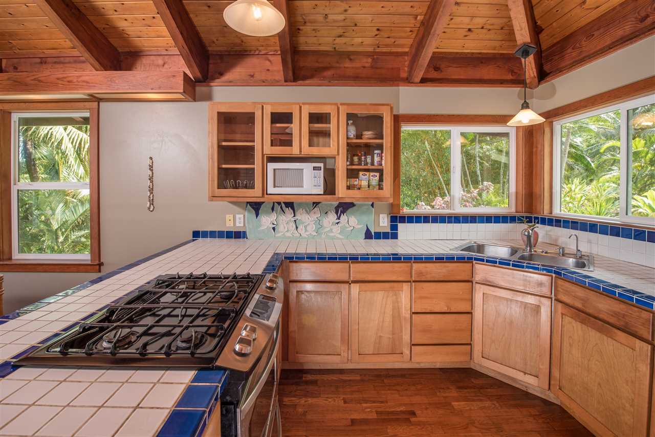 101 West Waipio Road Haiku, HI 96708 - Photo 13 of 30 a kitchen with stainless steel appliances granite countertop a stove a sink and a granite counter tops