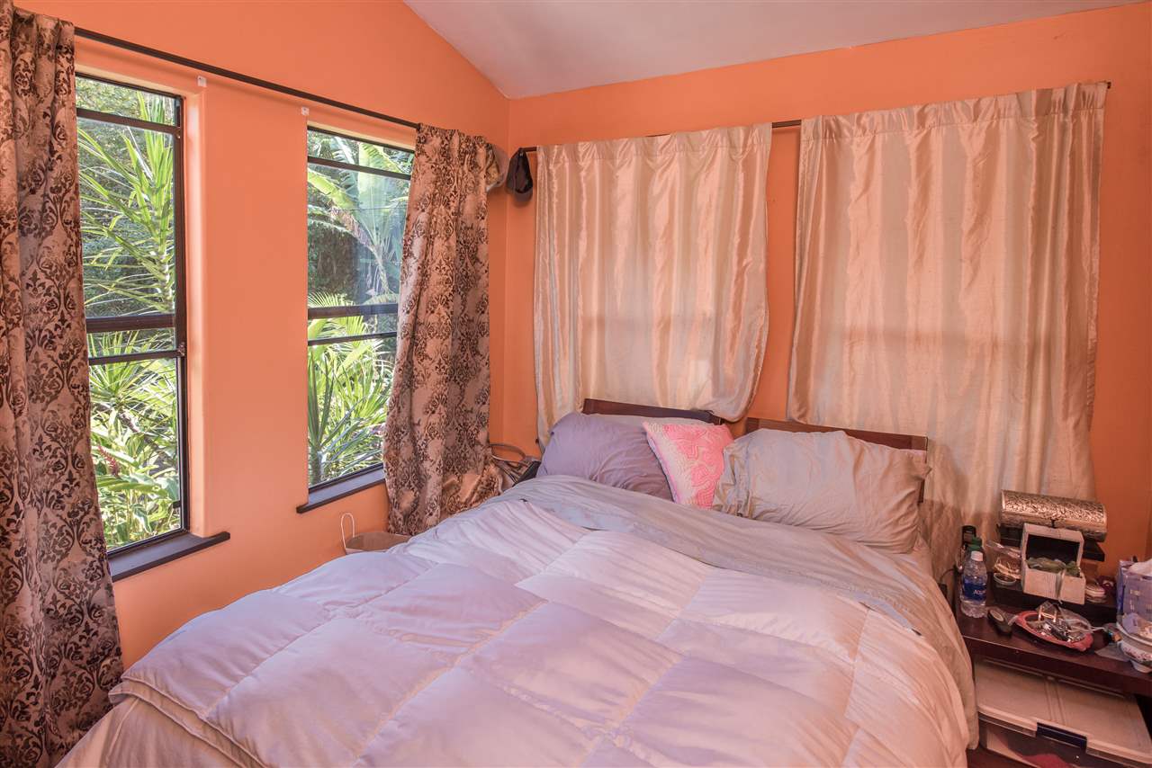 101 West Waipio Road Haiku, HI 96708 - Photo 25 of 30 a bedroom with a bed and a window