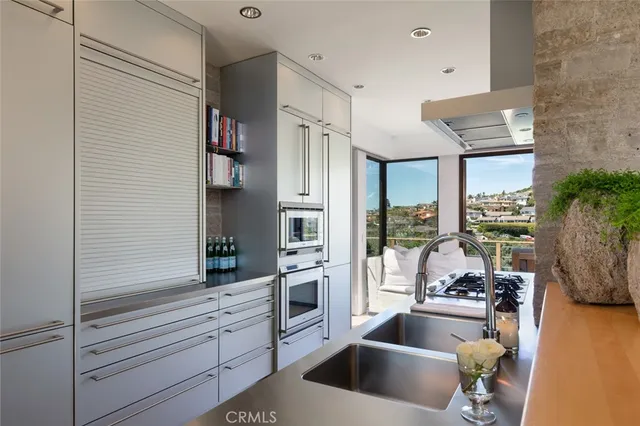 a kitchen with stainless steel appliances kitchen island granite countertop a refrigerator and a stove