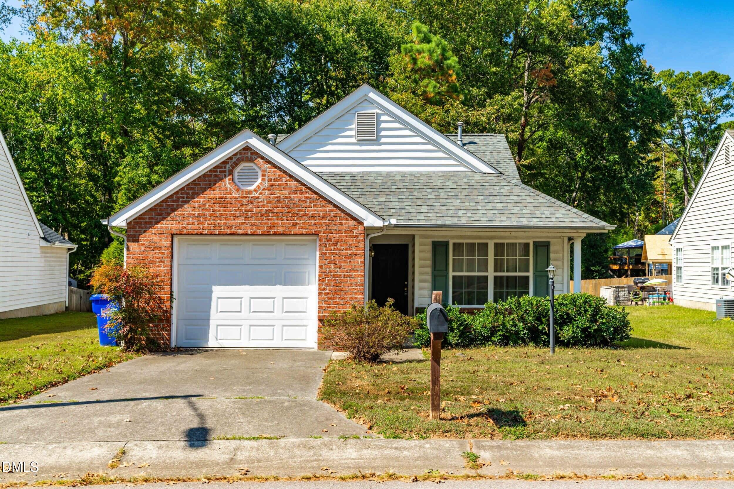 6010 Newhall Road Durham, NC 27713 - Photo 1 of 21 a front view of a house with garden