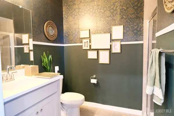 a bathroom with a sink a toilet and a mirror