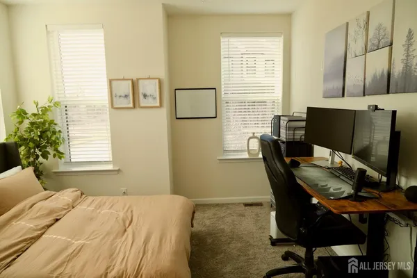 a bed sitting in a bedroom next to a window